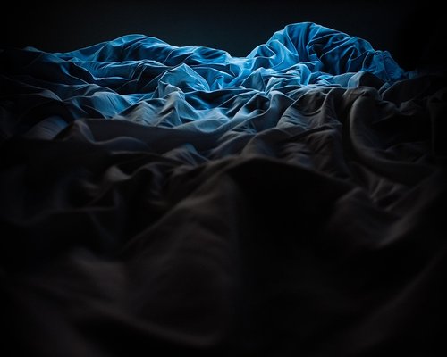 Cozy and dark bedroom prepared for a restful night
